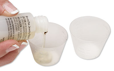 Pouring resin into a small cup